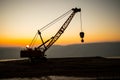 Abstract Industrial background with construction crane silhouette over amazing sunset sky. Tower crane against the evening sky. Royalty Free Stock Photo