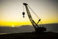 Abstract Industrial background with construction crane silhouette over amazing sunset sky. Tower crane against the evening sky. Royalty Free Stock Photo