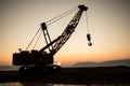 Abstract Industrial background with construction crane silhouette over amazing sunset sky. Tower crane against the evening sky. Royalty Free Stock Photo