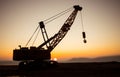 Abstract Industrial background with construction crane silhouette over amazing sunset sky. Tower crane against the evening sky. Royalty Free Stock Photo