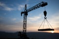 Abstract Industrial background with construction crane silhouette over amazing sunset sky. Tower crane against the evening sky. Royalty Free Stock Photo