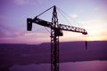 Abstract Industrial background with construction crane silhouette over amazing sunset sky. Tower crane against the evening sky. Royalty Free Stock Photo