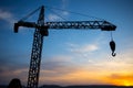 Abstract Industrial background with construction crane silhouette over amazing sunset sky. Tower crane against the evening sky. Royalty Free Stock Photo