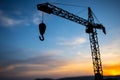 Abstract Industrial background with construction crane silhouette over amazing sunset sky. Tower crane against the evening sky. Royalty Free Stock Photo