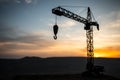 Abstract Industrial background with construction crane silhouette over amazing sunset sky. Tower crane against the evening sky. Royalty Free Stock Photo