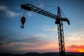 Abstract Industrial background with construction crane silhouette over amazing sunset sky. Tower crane against the evening sky. Royalty Free Stock Photo