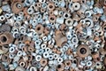 Abstract industrial old background with rusty used nuts for wallpaper many metalware