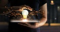 Abstract. Innovation. Hands holding tablet with light bulb future