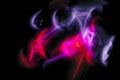 Abstract irregular purple and red light on black background. Long exposure. Light painting photography Royalty Free Stock Photo
