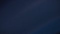 Abstract 4K gradient background featuring deep navy blue hues with a subtle grainy texture and soft blur effect. Perfect for