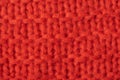 Abstract knitted red coral knitted background close up.