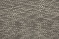 Abstract knitted texture of dark beige color