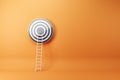 Abstract ladder leading to bulls eye target on orange wall background with mock up place. Targeting, career and aim concept. 3D