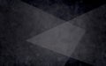 Abstract layers of black white and gray triangles on textured black background in elegant geometric design