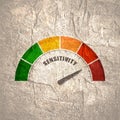 Sensitivity measuring device with arrow and scale.