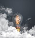 abstract light bulb glowing on dark grey background with clouds Royalty Free Stock Photo