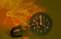 Abstract a light bulb with soot from working and a black analog clock. Show the concept of saving resources on the planet, Royalty Free Stock Photo
