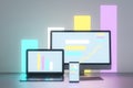 Abstract light neon designer desktop with glowing laptop computer monitors, smartphone screen and business charts, graphs and Royalty Free Stock Photo