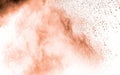 Abstract light orange powder explosion on white background. Freeze motion of light orange dust particles splash Royalty Free Stock Photo