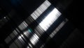 Abstract light patterns create a dynamic interaction of diagonal light and shadow.