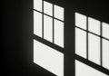 Monochromatic geometric shadows cast by window panes on a wall Royalty Free Stock Photo