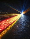 Abstract light source projecting colorful rays on a black textured surface Royalty Free Stock Photo