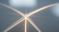 Abstract light streaks forming an x shape against a blurry gray background with bright highlights Royalty Free Stock Photo