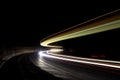 Abstract lights in a car tunnel in white, green, orange