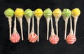Abstract line of 12 striped lollipops