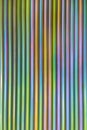An abstract lines backround of colorful cadmium coated steel bars. Vertical orientation and direction.