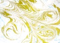 Abstract liquid gold background. Pattern with abstract golden and black waves. Marble. Handmade surface. Liquid paint. Draw, mater