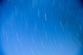 Abstract long exposure of star trails in blue sky for background Royalty Free Stock Photo