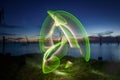 Abstract luminous light painting on the shore of the lake