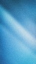 Abstract luminous vertical background with a dramatic diagonal light ray, featuring a detailed grainy blur texture in vibrant blue Royalty Free Stock Photo