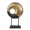 Abstract luxury interior accessory of a half golden circle with a hole with patterns on black stand Royalty Free Stock Photo