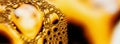 Abstract macro background of effervescing golden champagne bubbles Royalty Free Stock Photo