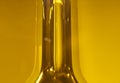 The Neck of a Glass Olive Oil Bottle with Yellow Background