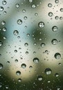 Abstract macro shot featuring raindrops on a window surface with blurred background creating a Royalty Free Stock Photo