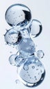 Abstract macro shot of transparent liquid spheres with tiny bubbles floating against a soft light blue background Royalty Free Stock Photo