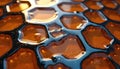 Abstract macro view of hexagonal cells filled with golden liquid. Symmetrical pattern forms a hive-like structure with chrome Royalty Free Stock Photo