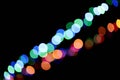 Abstract magic background with bokeh effect. Two multicolored garlands, defocused bokeh lights on an isolated black Royalty Free Stock Photo