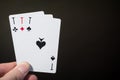 Abstract: man hand holding playing card three ace isolated on black background with copyspace poker set four eight Royalty Free Stock Photo