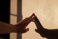 Abstract man hand touch wall with sunset light and long shadows Royalty Free Stock Photo