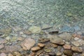 Abstract sea background with water covering stones and pebbles. Vertical orientation Royalty Free Stock Photo