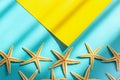 Abstract marine sea background. Yellow and blue paper background with starfishes, hard light and shadow. Concept Royalty Free Stock Photo
