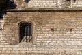 Abstract medieval brick wall with barred window