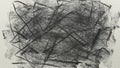 An abstract, messy charcoal scribble on a piece of textured white paper. Royalty Free Stock Photo