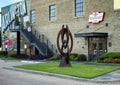 'Momentum', an abstract metal sculpture in front of the historic Vandergriff Office Building in Arlington, Texas. Royalty Free Stock Photo