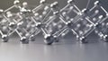 Abstract metallic molecular structure with reflective spheres and connecting rods on a gray surface Royalty Free Stock Photo