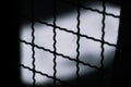 Abstract Minimal style black and whith rays of sunlight cast shadows on the wire mesh steel metal Royalty Free Stock Photo